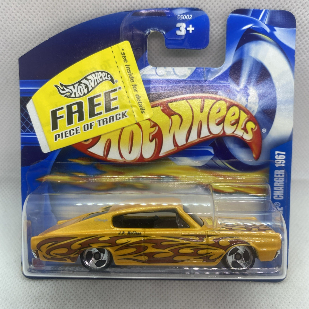 Yellow Hot Wheels die-cast car in blue blister card, front view with flame graphics