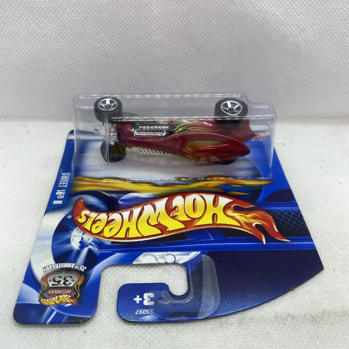 Hot Wheels die-cast car in blister pack, maroon and silver with flame decals