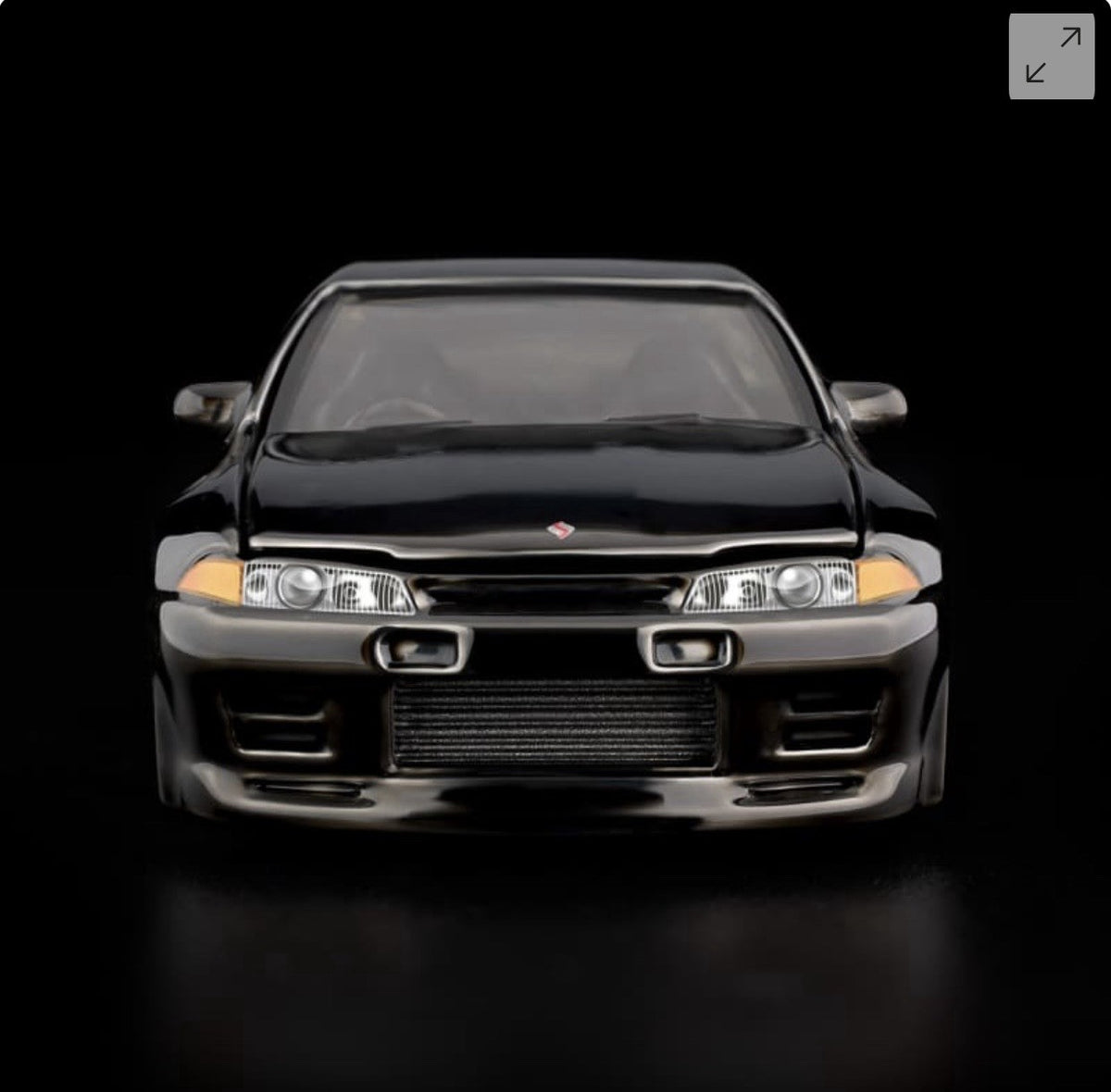 Die-cast sports car model, front view with twin headlights and chrome front bumper