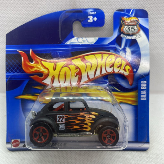 Die-cast toy car in blister pack, black body with flame graphics, red wheel rims.