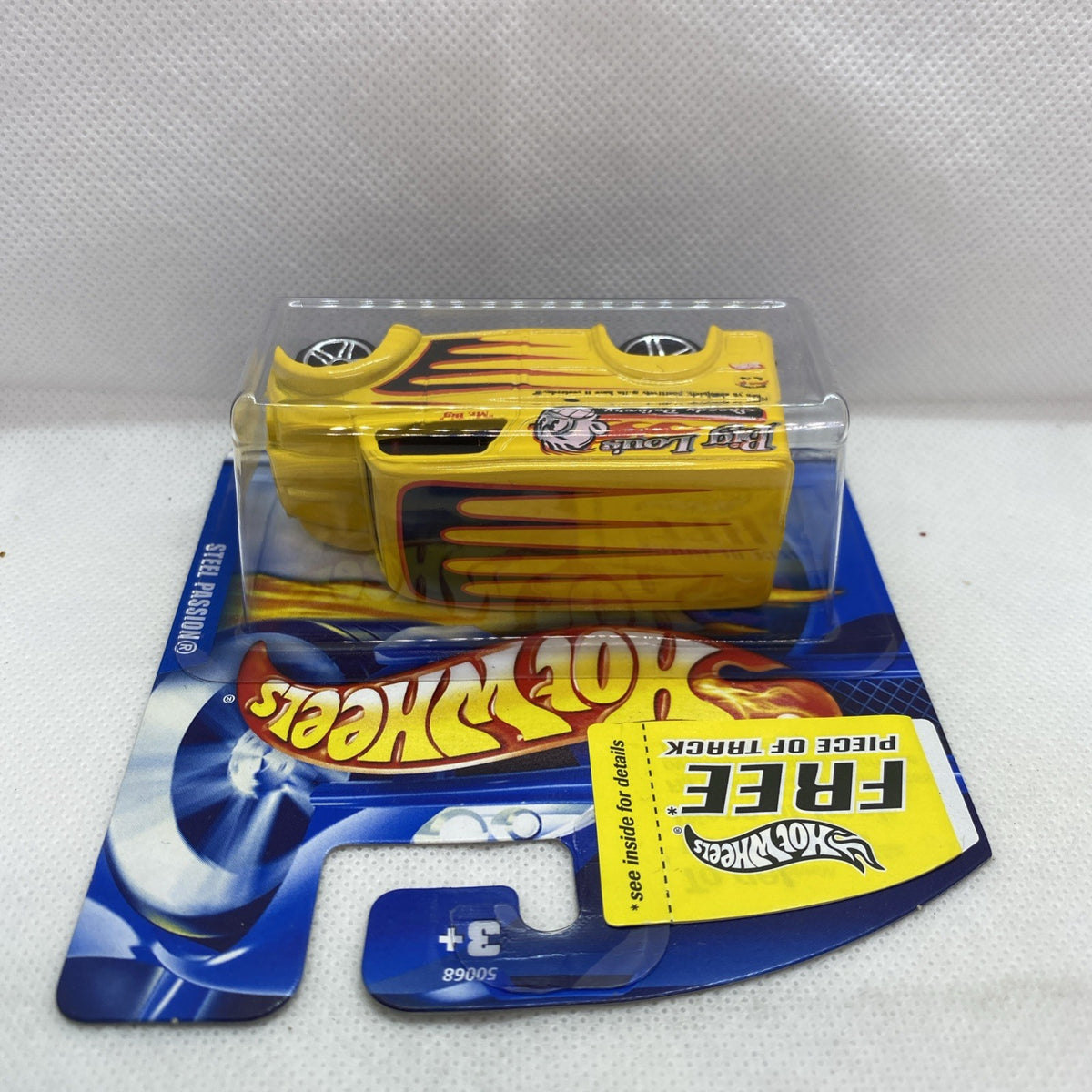Yellow Hot Wheels die-cast car with flame decals in clear blister packaging.