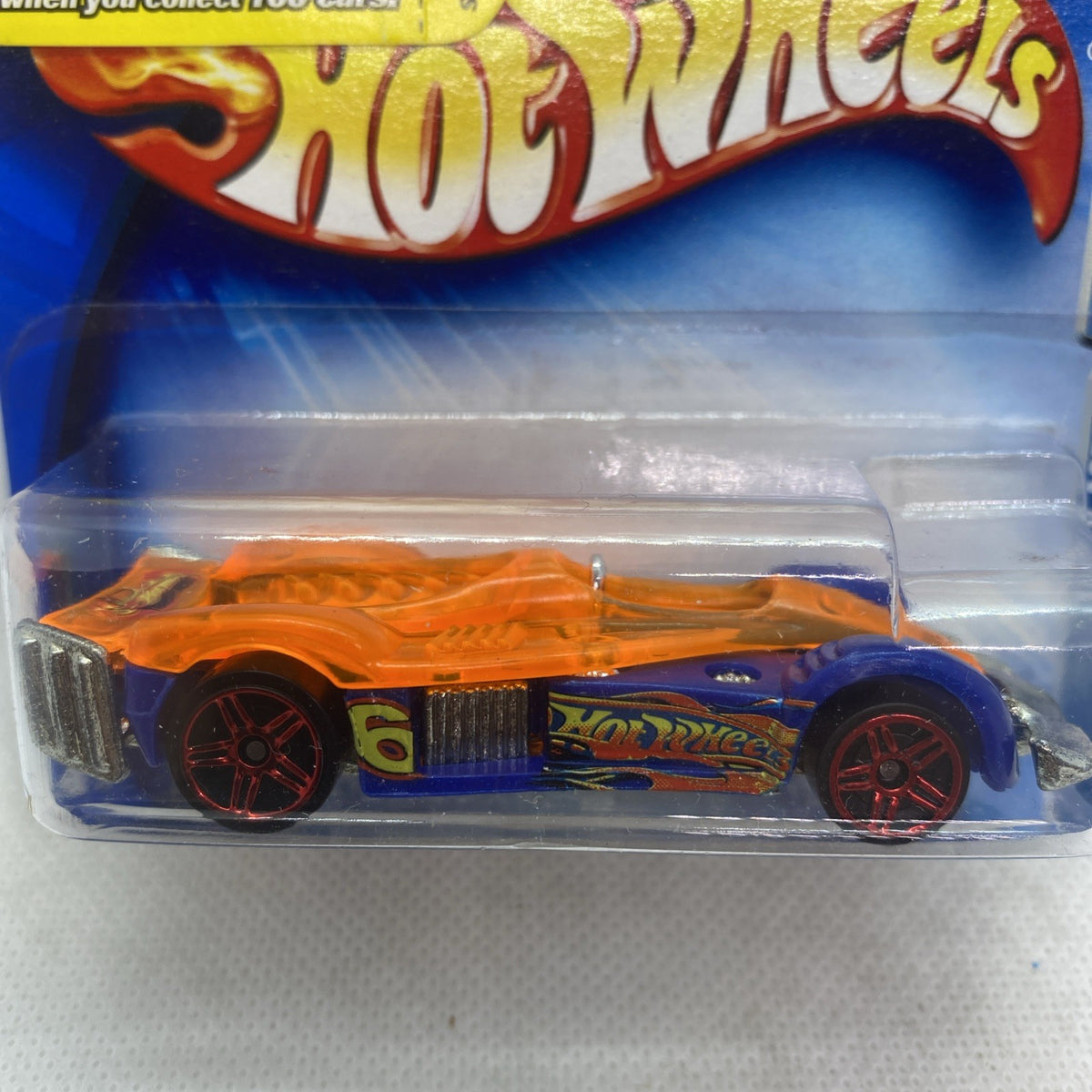 Hot Wheels Road Rocket die-cast car in blister, close-up of orange front and wheels