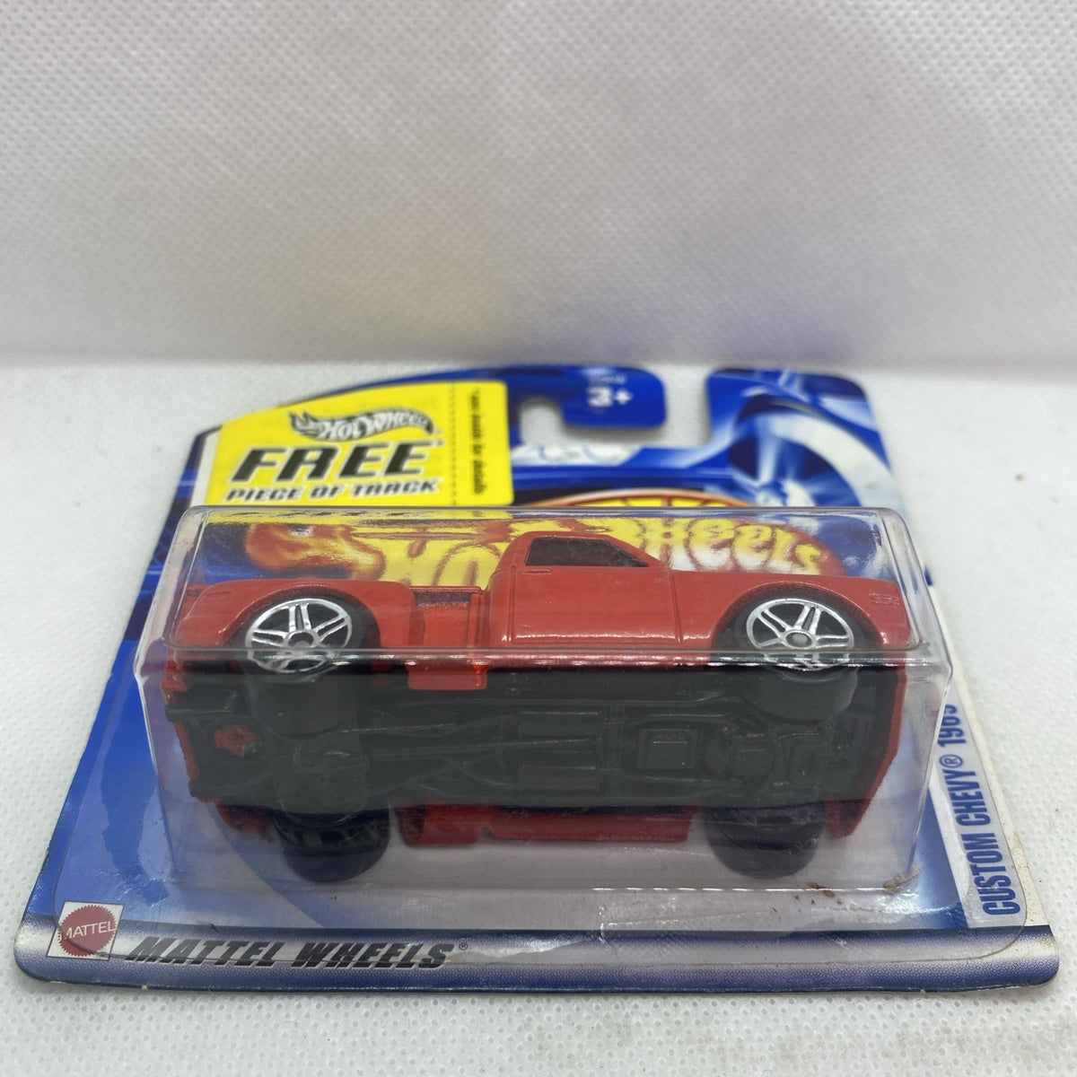 Red Hot Wheels die-cast car in clear blister on blue card, chrome wheels shown