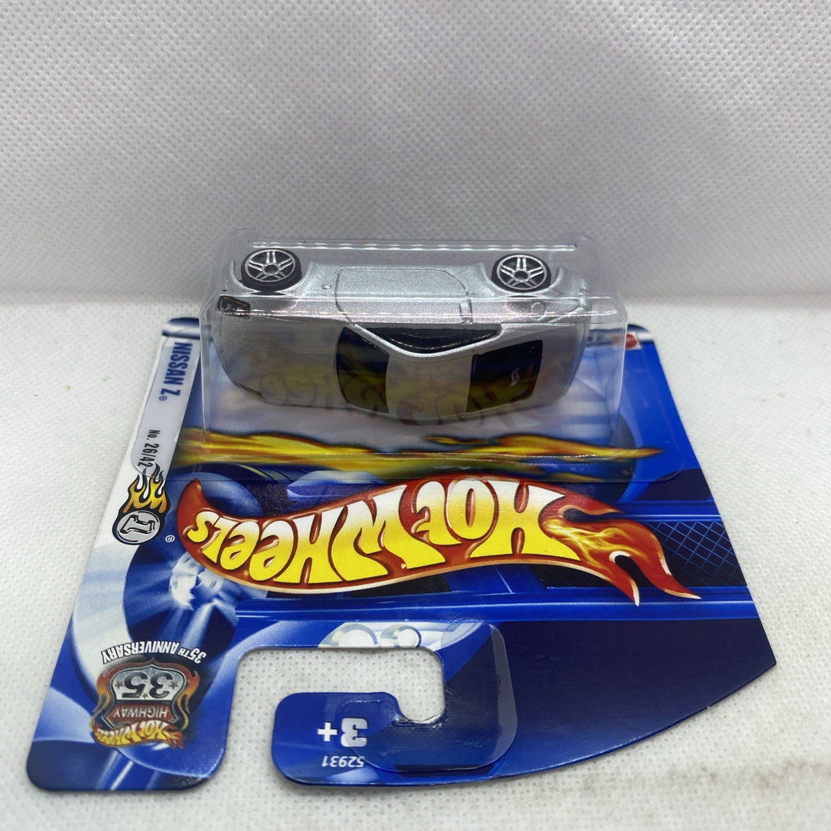 Hot Wheels die-cast Nissan Z 2002 car with silver-gray roof in clear blister