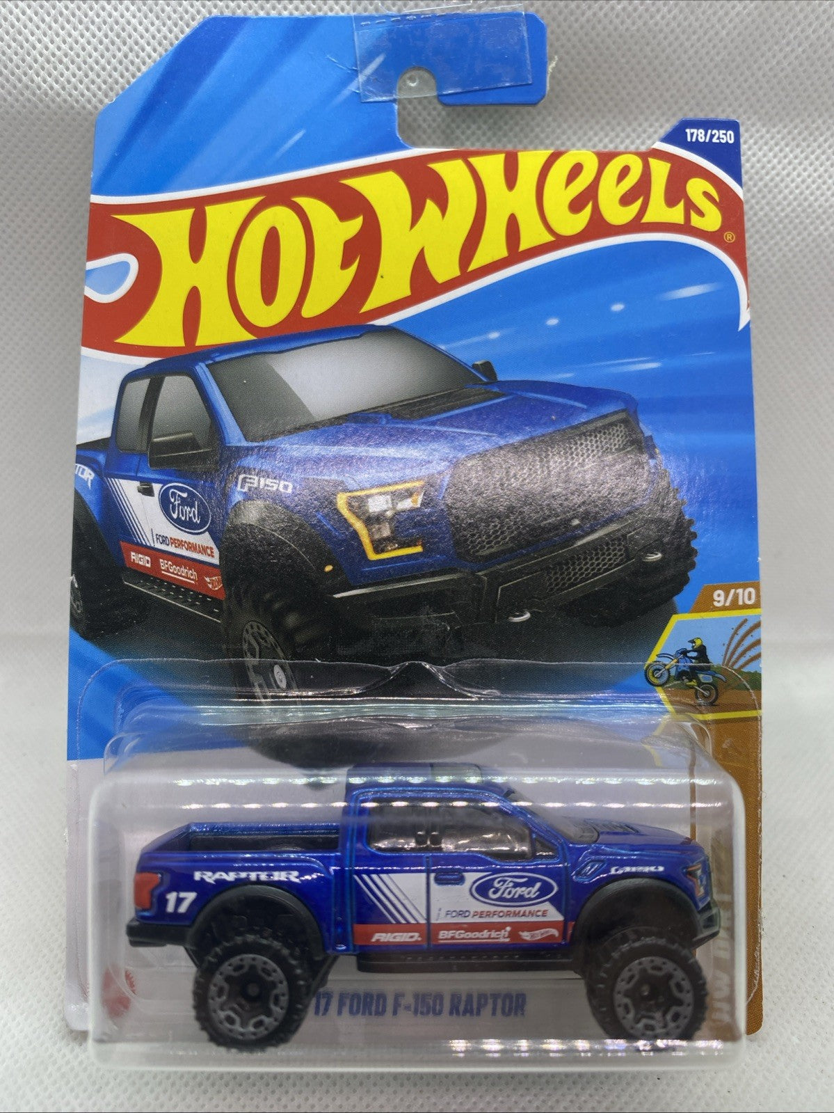 Blue Hot Wheels die-cast F-150 Raptor toy truck in sealed blister card