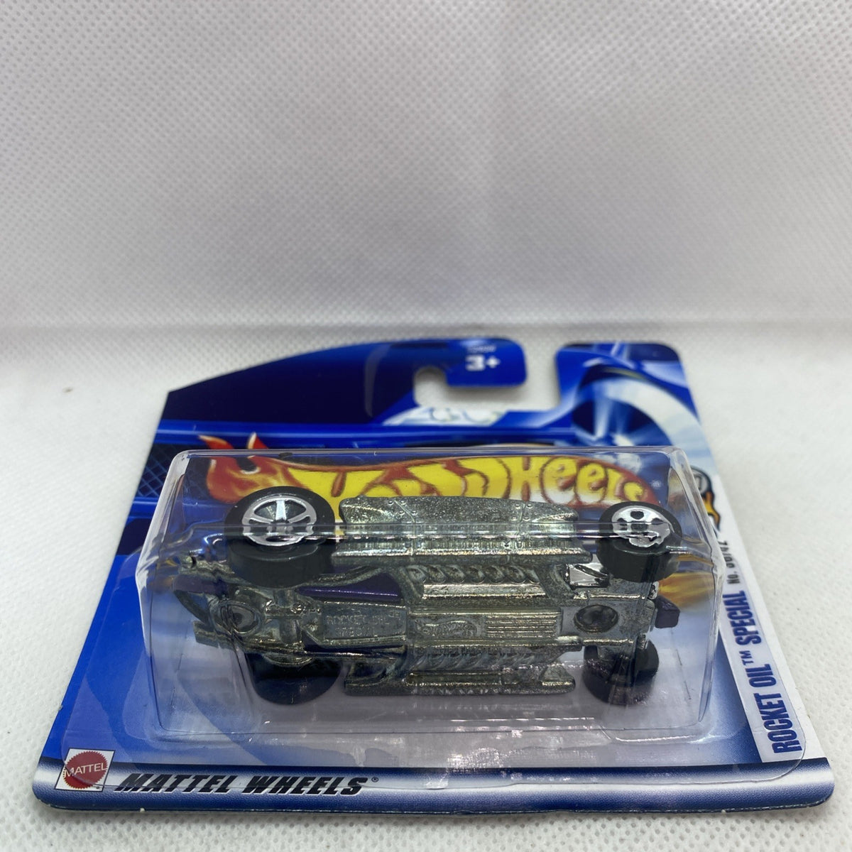Hot rod die-cast in clear blister on Hot Wheels Rocket Oil short card, angled view