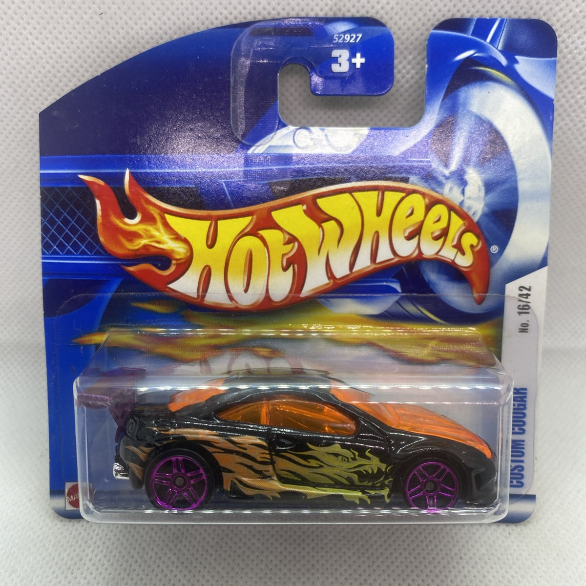 Hot Wheels die-cast car with orange flames graphics, black body, and purple spoke wheels