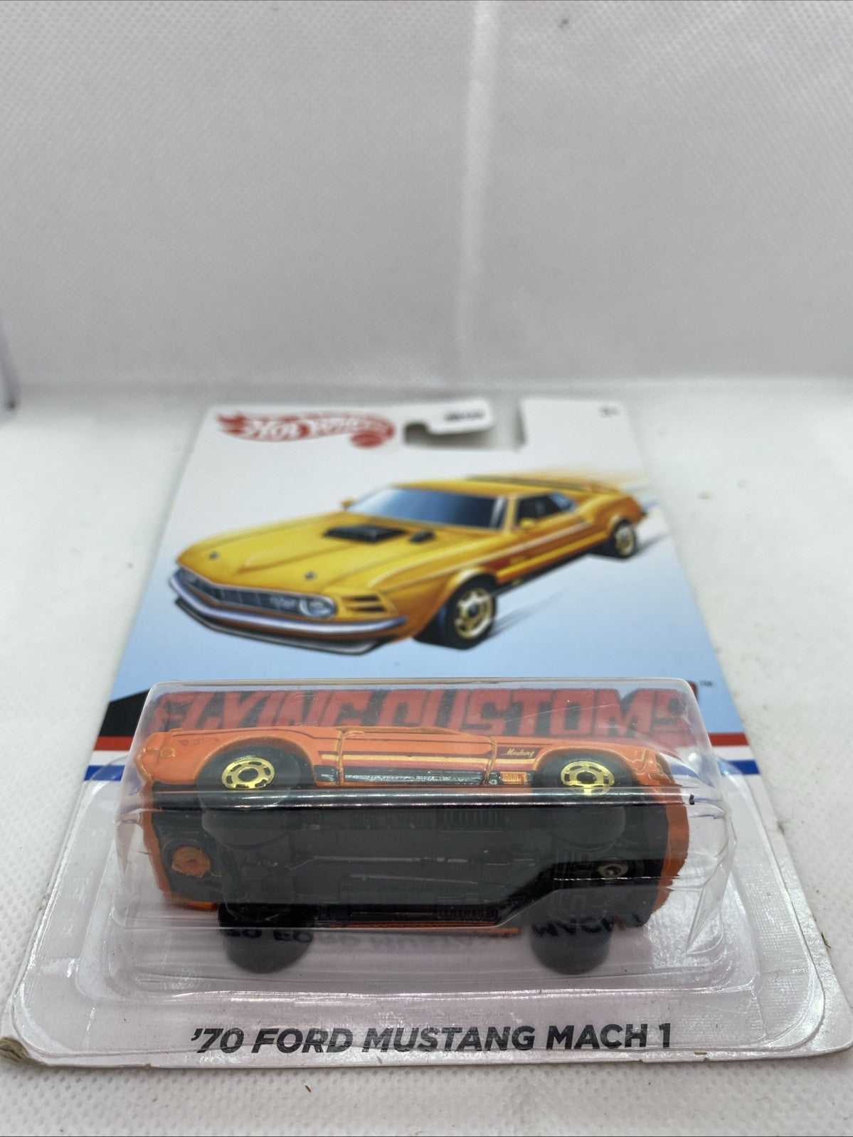 Hot Wheels '70 Ford Mustang Mach 1 blister pack with side-view orange car and card branding
