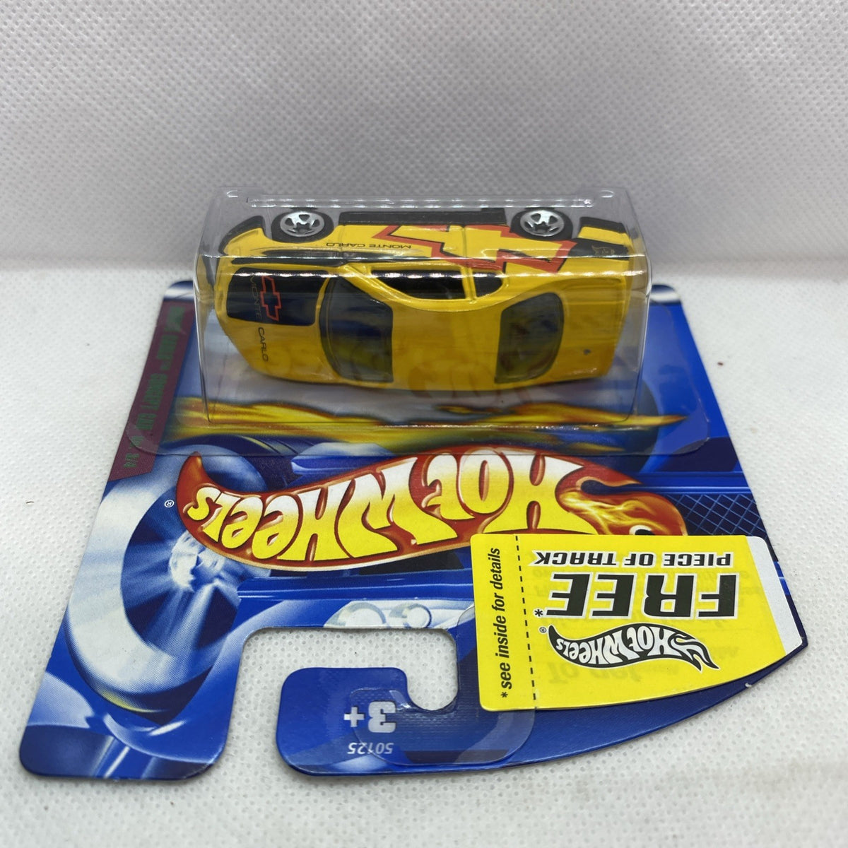 Hot Wheels yellow Monte Carlo concept die-cast car in blister, top angled view