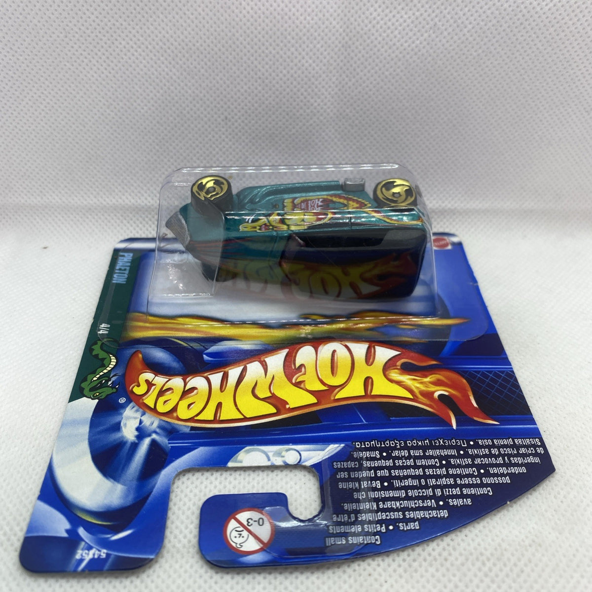 Hot Wheels die-cast car blister pack with teal car and flames, front angled view