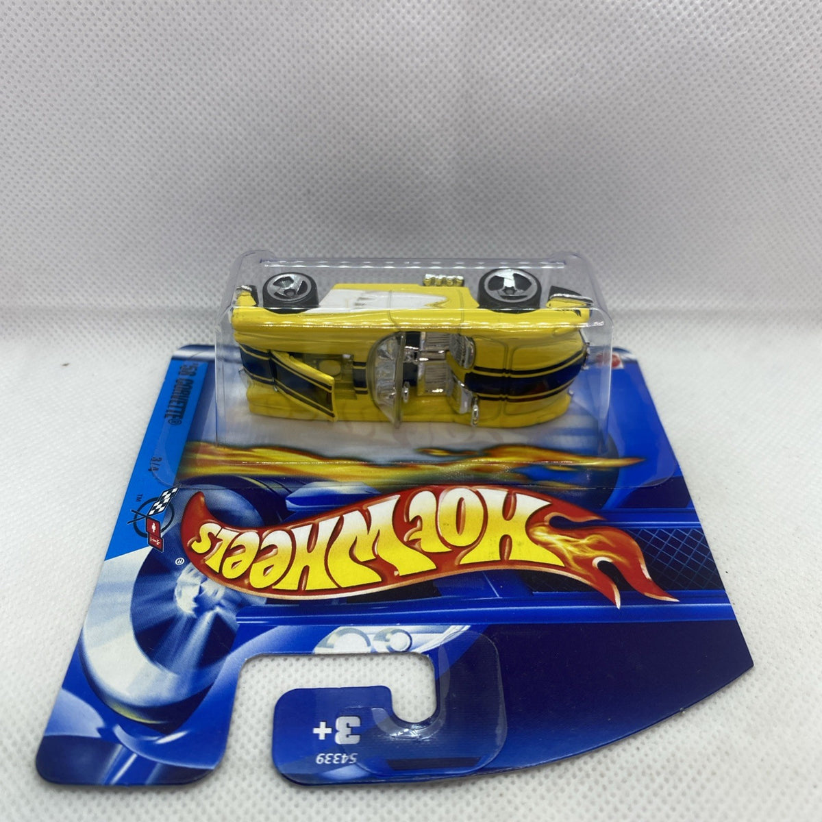 Hot Wheels 2002 Corvette #069 yellow die-cast car in blister on blue card