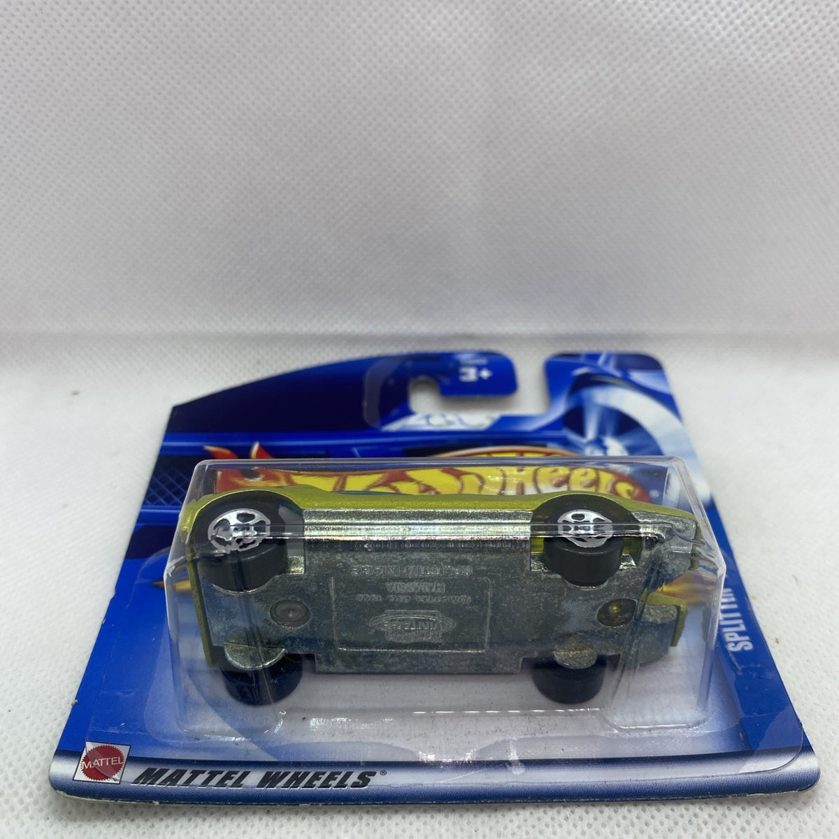 Hot Wheels die-cast car in blister pack with black underside visible