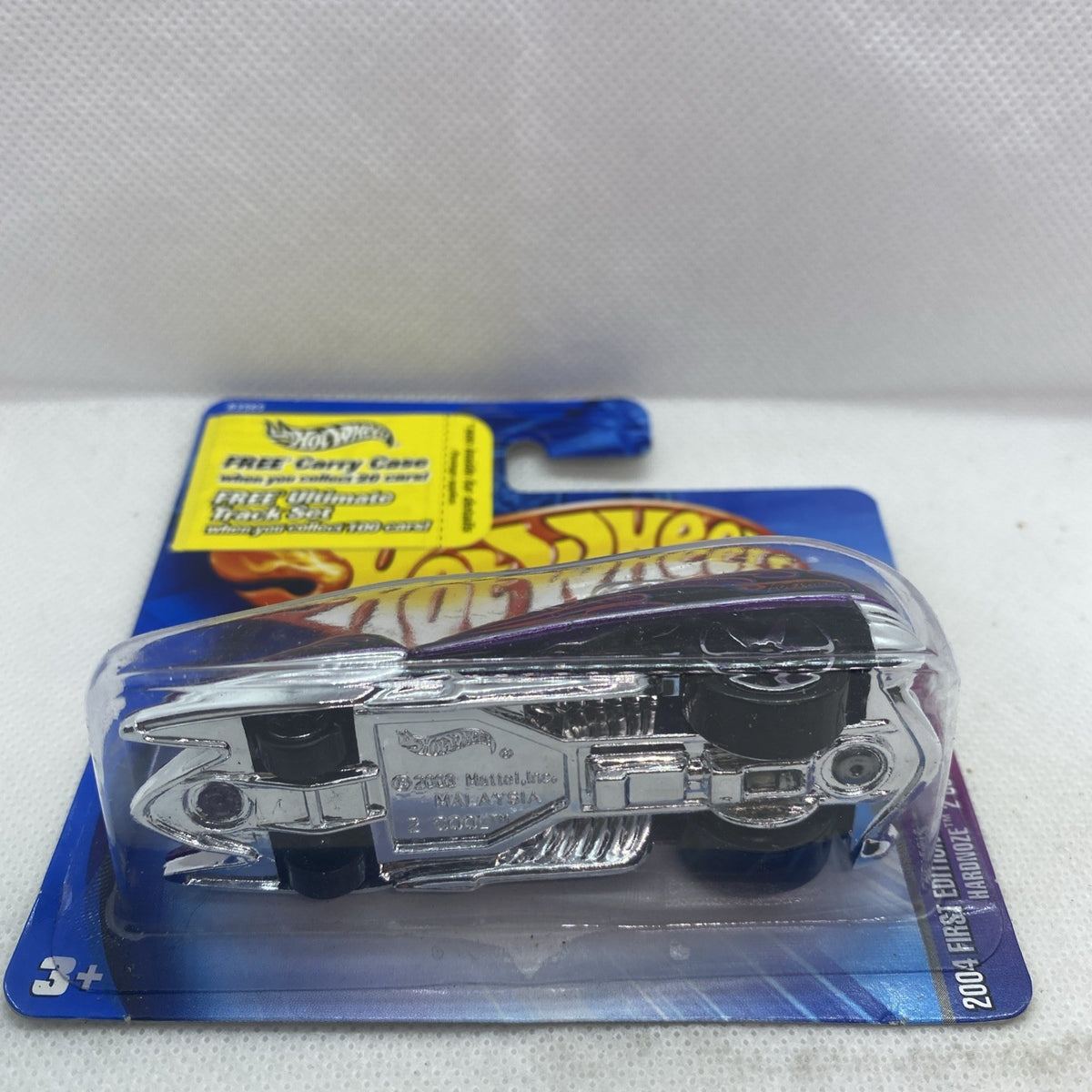 Hot Wheels die-cast car in blister, black chassis with chrome details on blue card