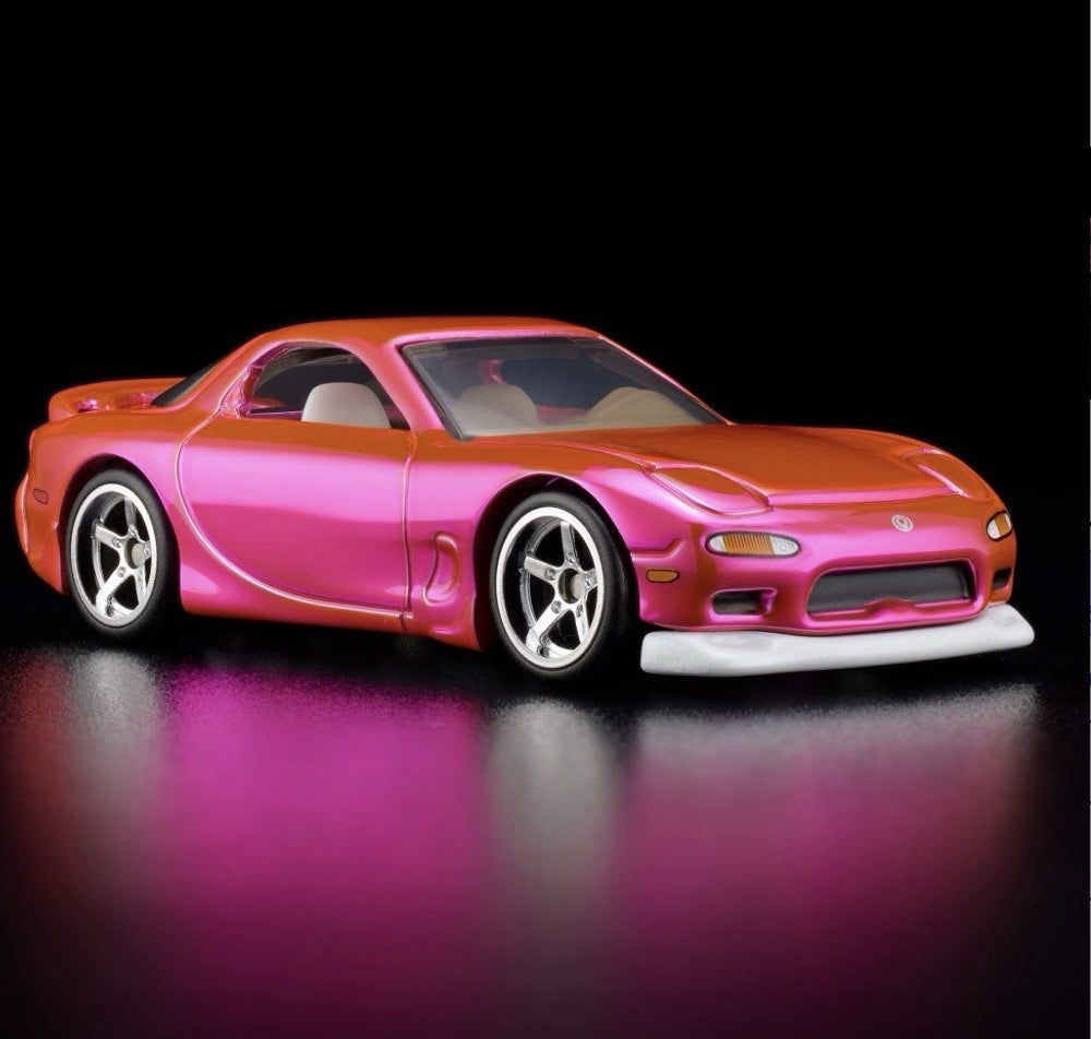 Pink and orange die-cast sports car with chrome wheels, side 3/4 view