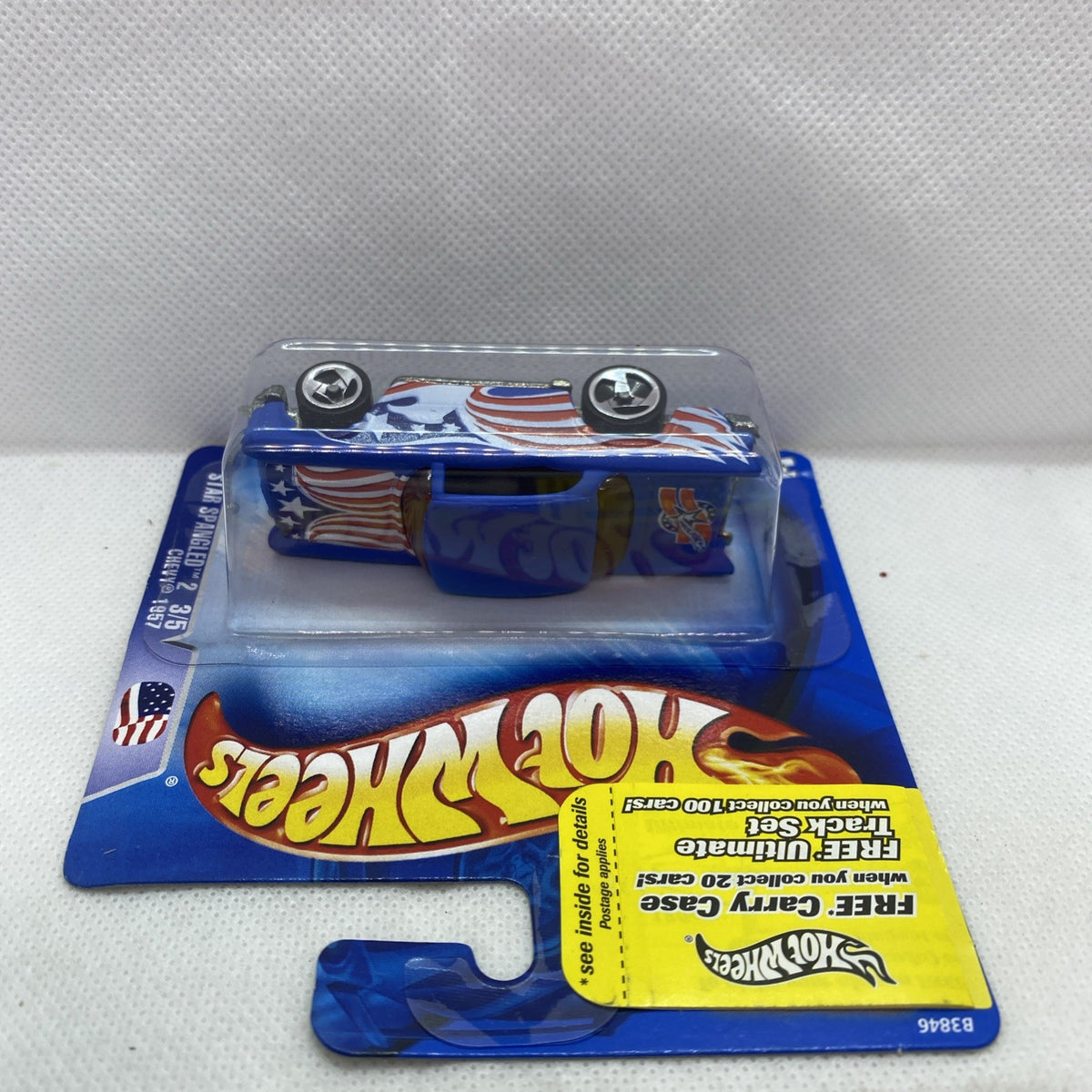 Hot Wheels 1957 Chevy die-cast car, short-card blister with star-and-stripe graphics