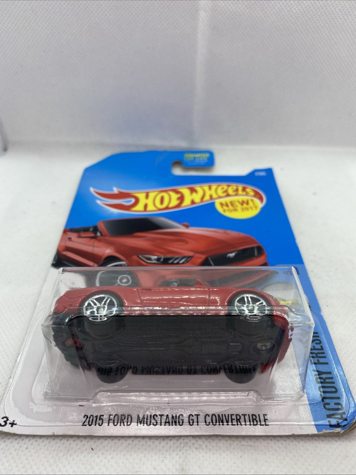 Hot Wheels red Mustang convertible toy in clear blister on blue top card