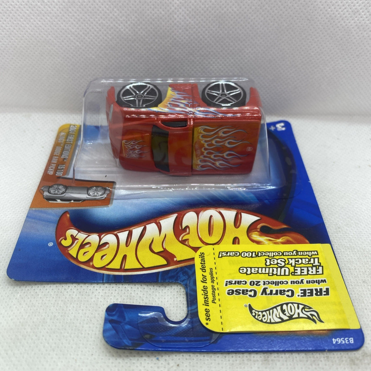 Hot Wheels Dodge Ram 2004 die-cast pickup, orange with flame decals, top view in pack