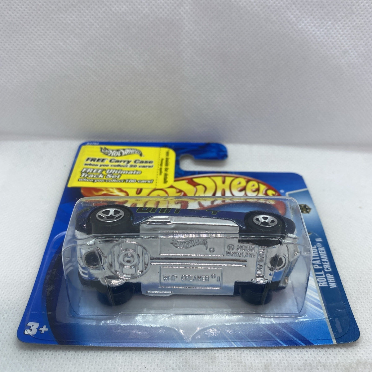 Back view of blue Hot Wheels car in clear blister, wheels and details visible, sealed