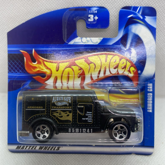 Hot Wheels armored car die-cast on blue blister card, black vehicle with yellow stripes