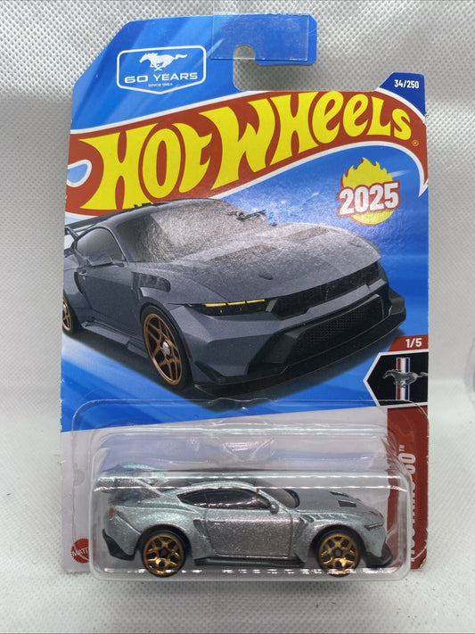 Hot Wheels die-cast Ford Mustang GTD 2025 on short card, silver body, gold wheels