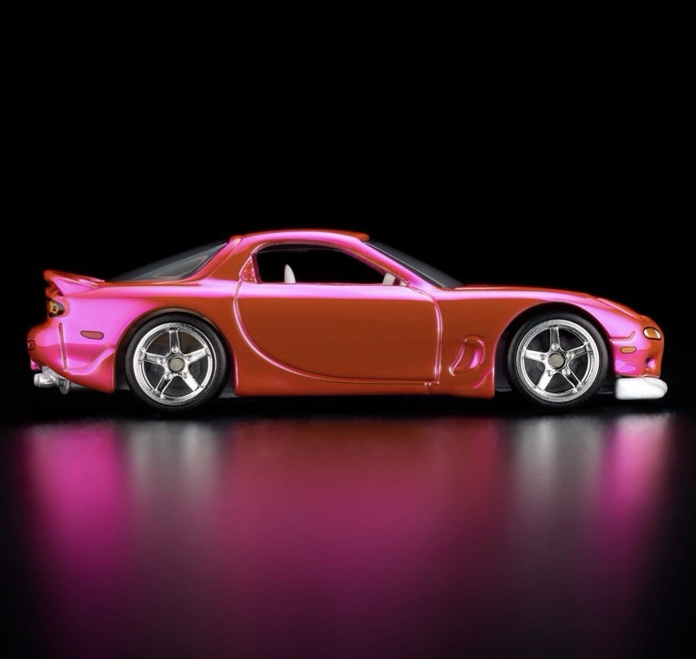 Pink and orange die-cast sports car with chrome wheels, side profile