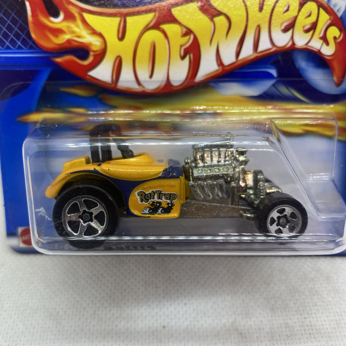 Hot Wheels Rat Trap die-cast car close-up in clear blister, yellow top and gray engine