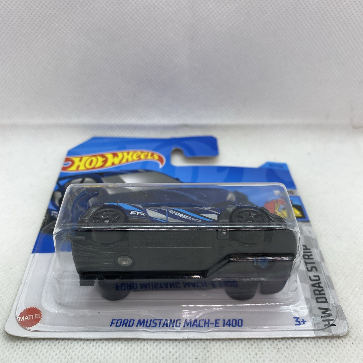 Hot Wheels die-cast Mustang Mach-E toy car showing rear view in blue blister pack