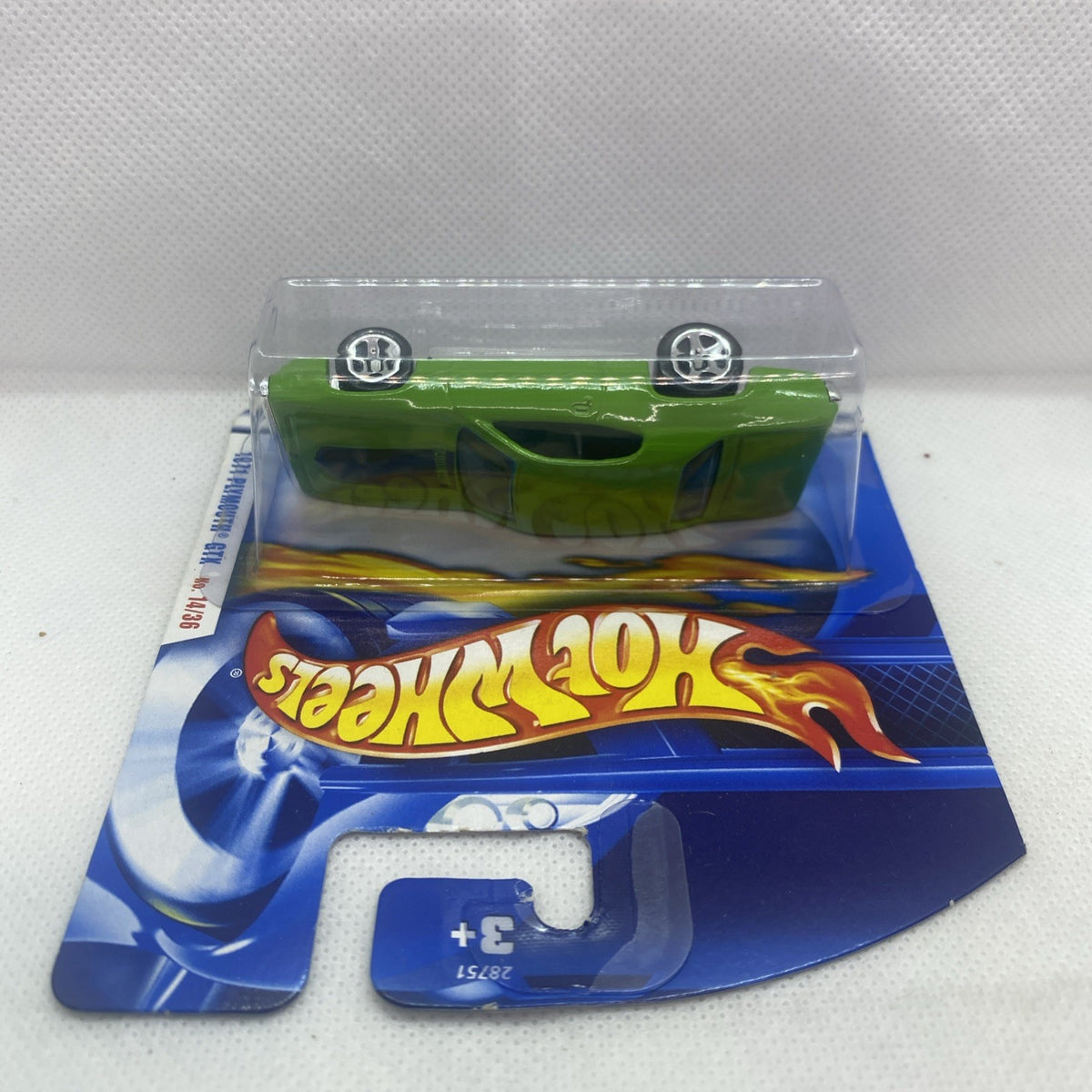 Lime green toy car viewed from above in blue retail blister pack