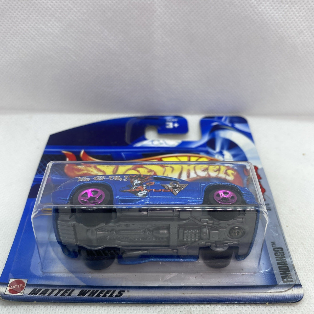 Hot Wheels sealed car blister, top view of blue truck with purple wheels.
