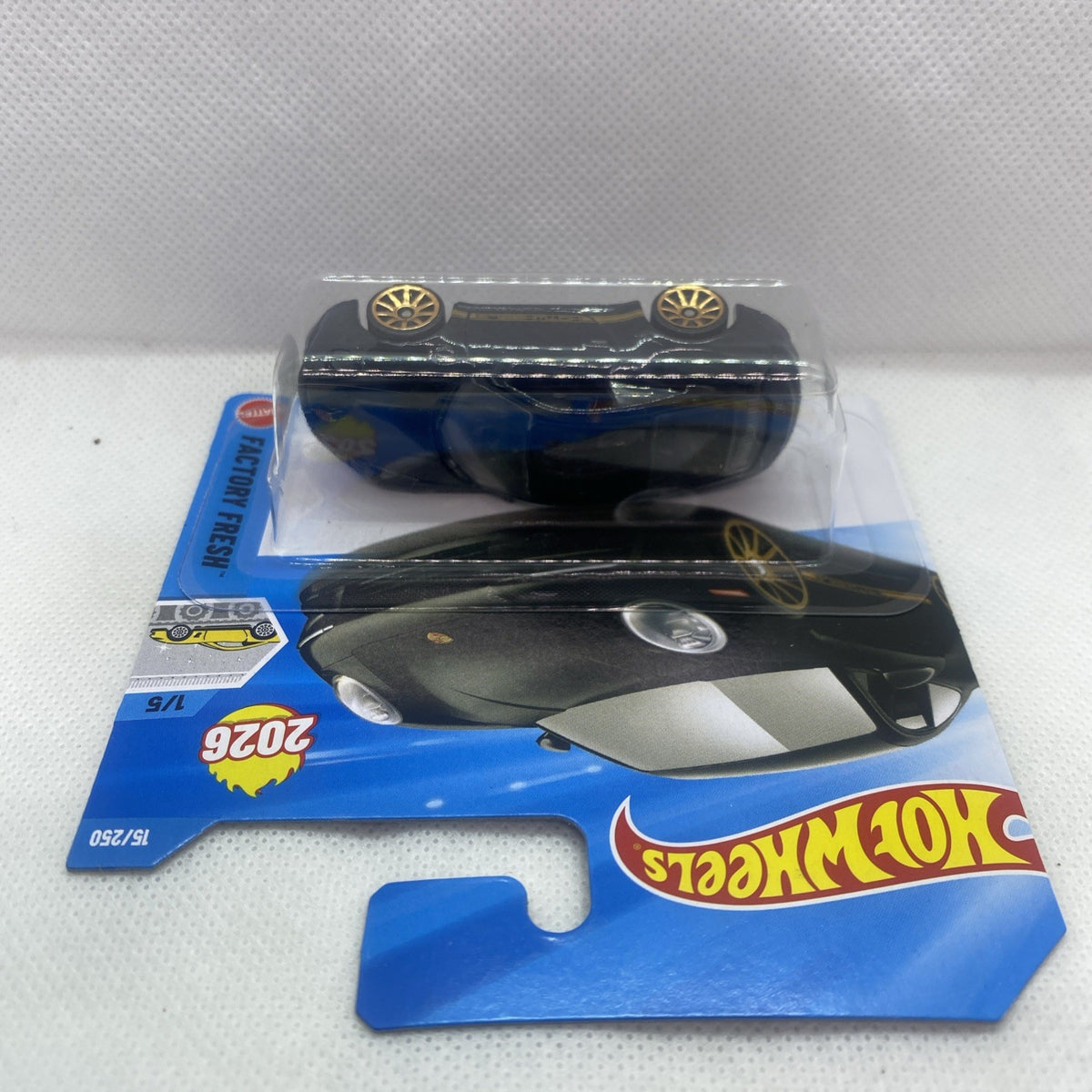 Hot Wheels black Porsche 911 Carrera T toy car shown from side in blister