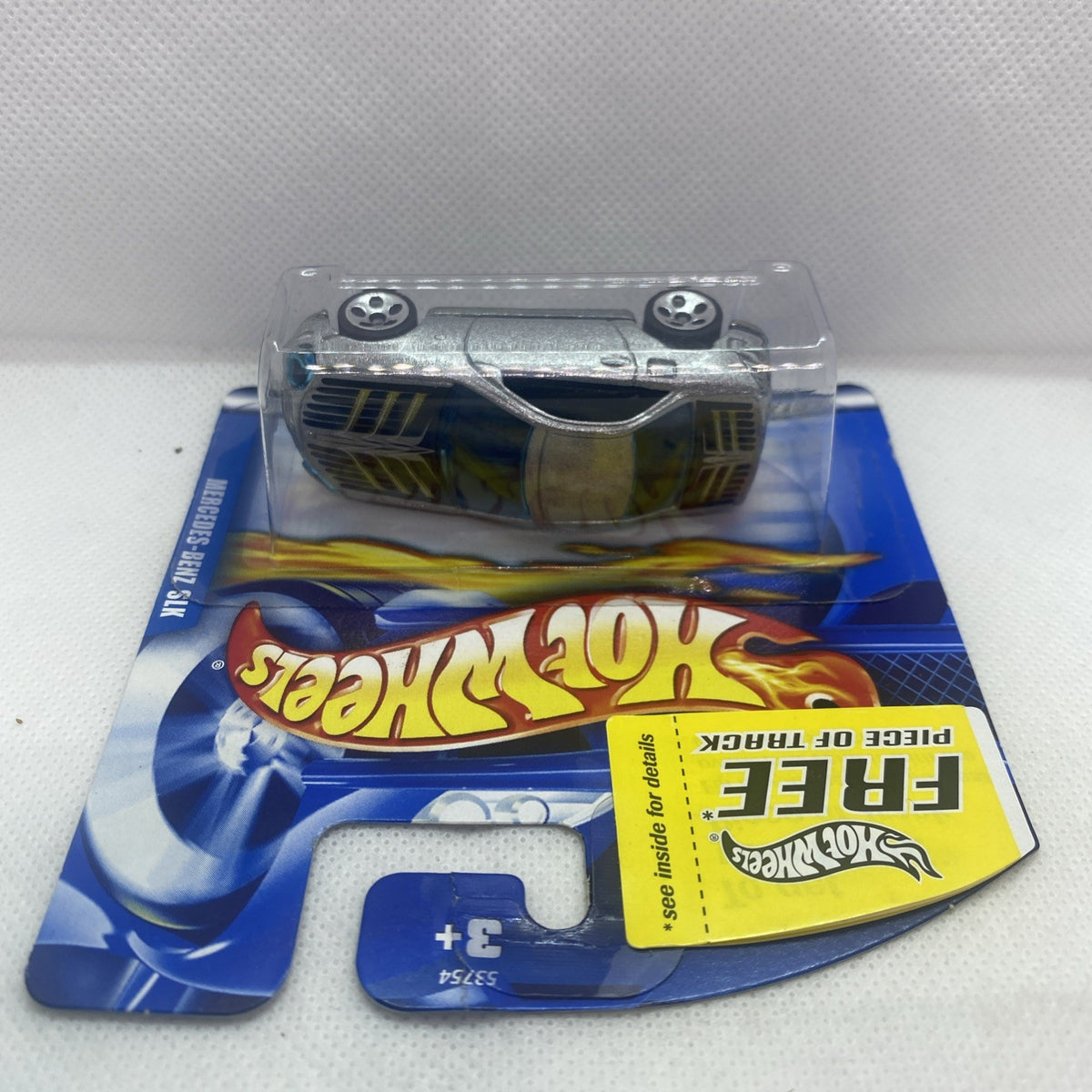 Hot Wheels Mercedes-Benz SLK 2001 toy car blister pack, wheels visible