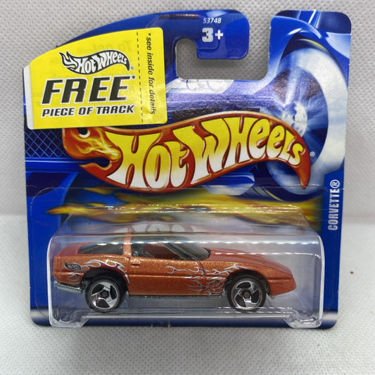 Orange die-cast Corvette toy car in blister pack with Hot Wheels Free track label