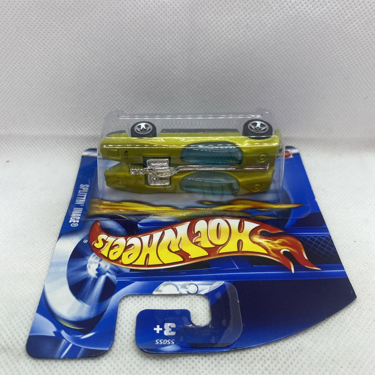 Green Hot Wheels die-cast car blister pack, rear view showing wheels
