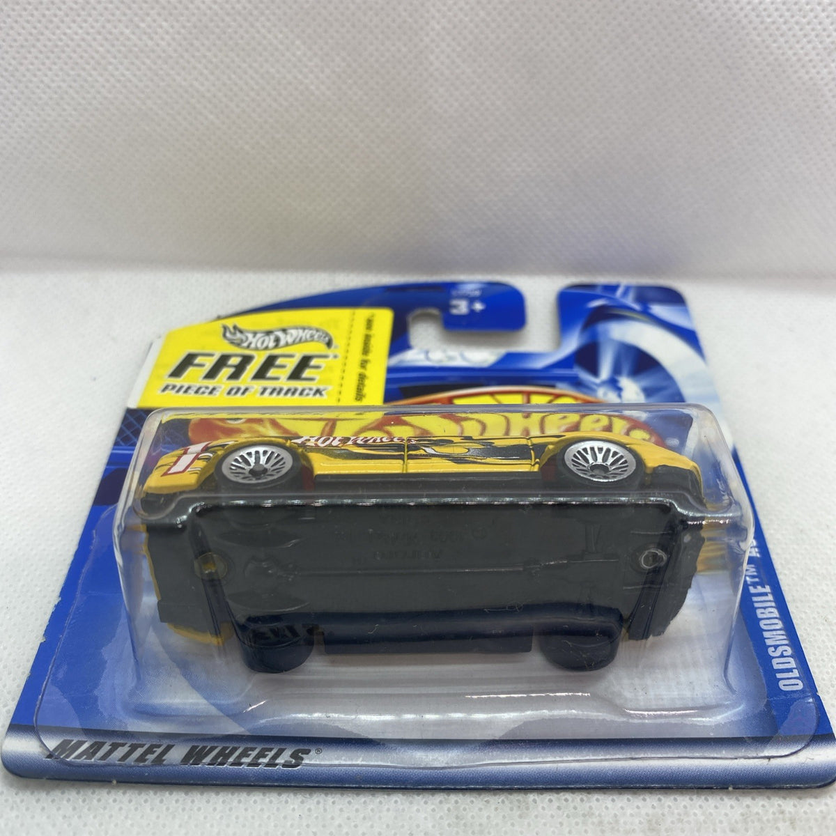 Hot Wheels Oldsmobile Aurora 2001 yellow die-cast car in clear blister, rear view