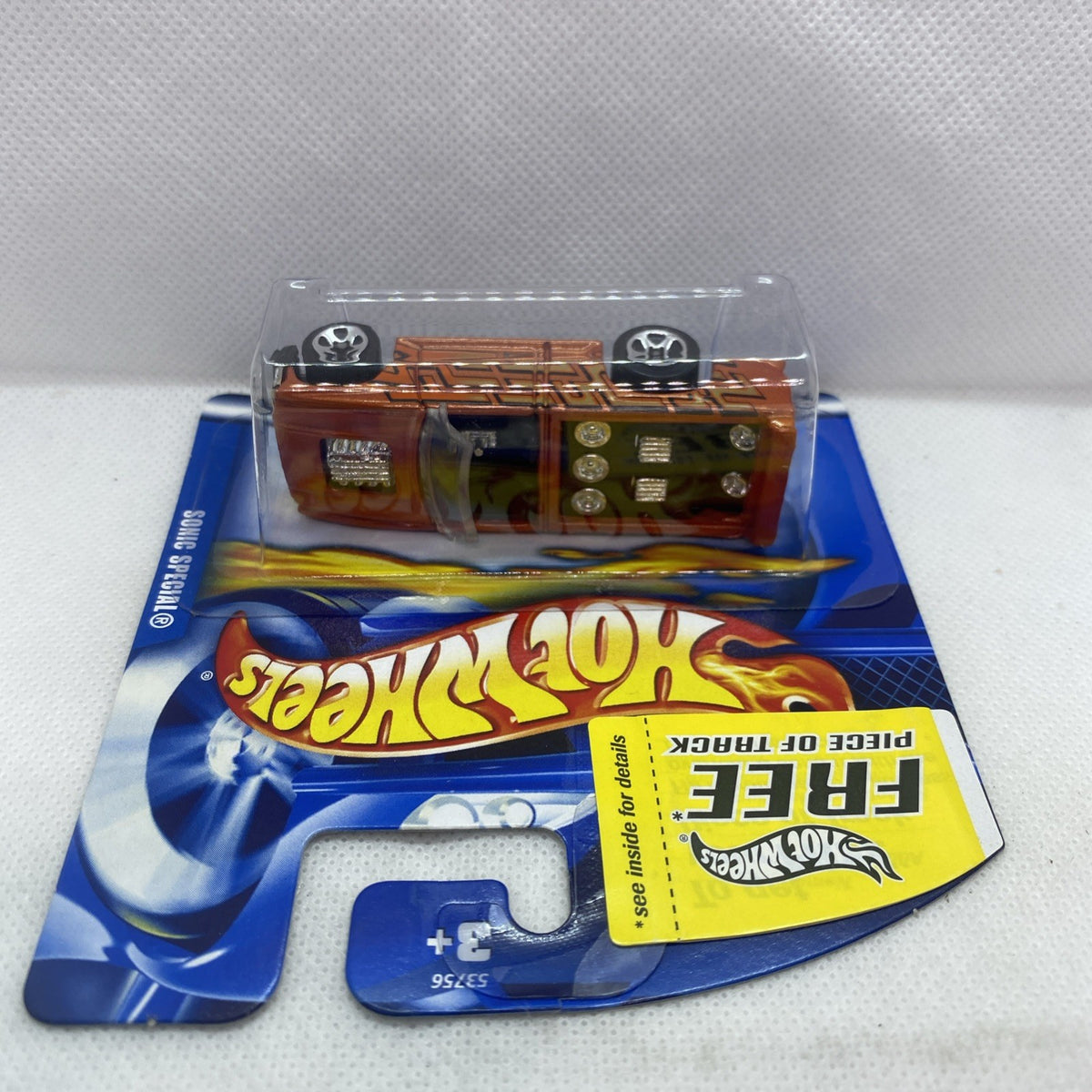Hot Wheels mini truck in orange on short card blister packaging