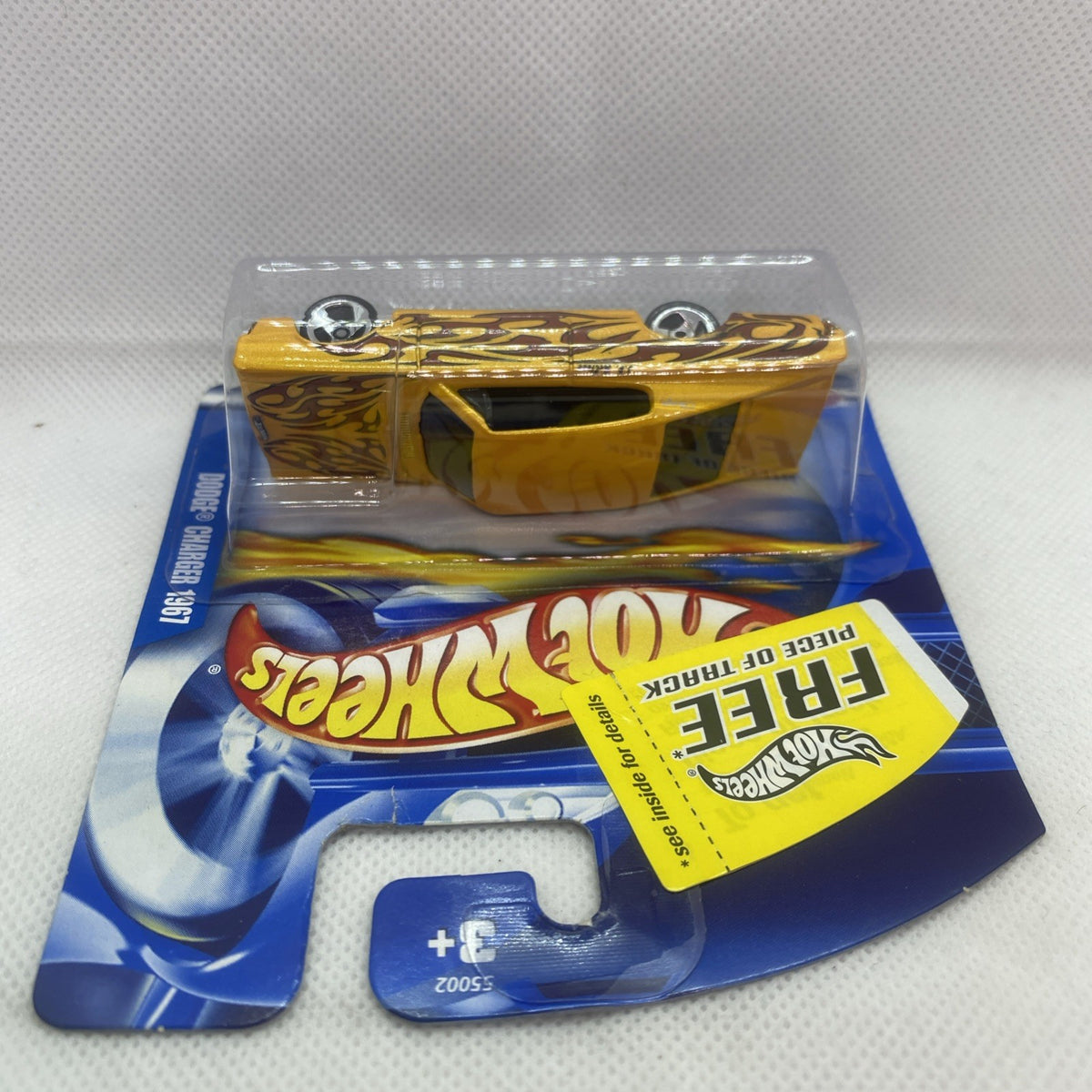 Yellow Hot Wheels die-cast car blister card, top view through clear plastic window