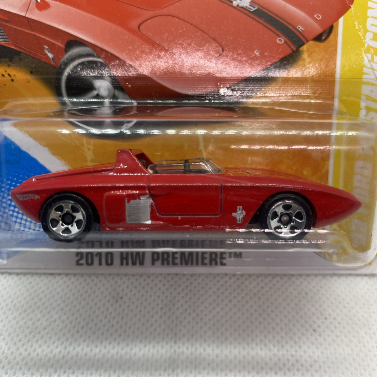 Red Mustang Concept die-cast car in blister, side view with silver wheels