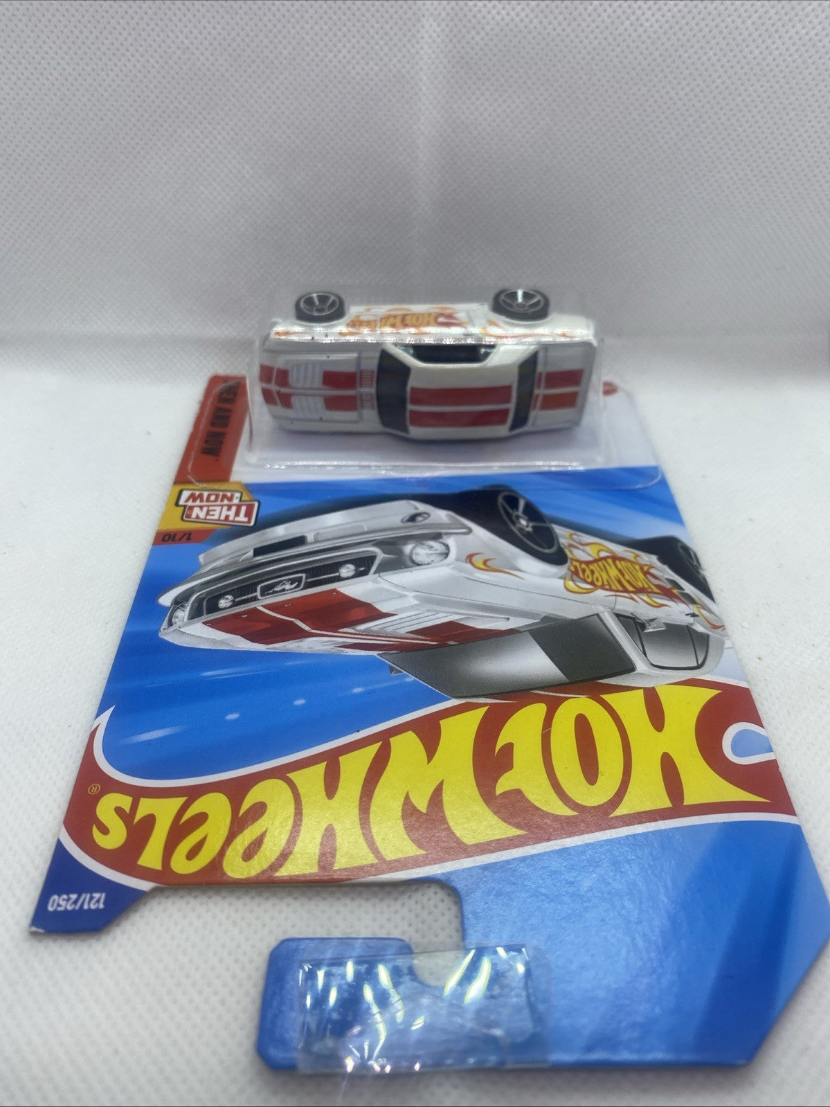 Hot Wheels die-cast car in blister pack with top card artwork and branding