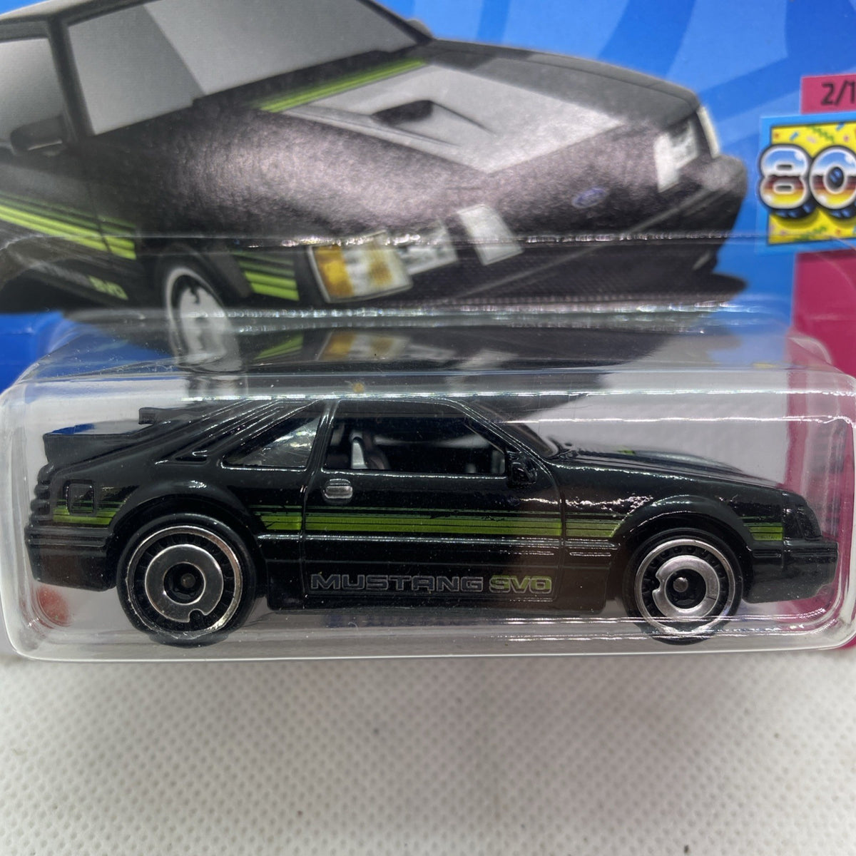 Close-up black Mustang SVO die-cast with green stripes, front grille visible
