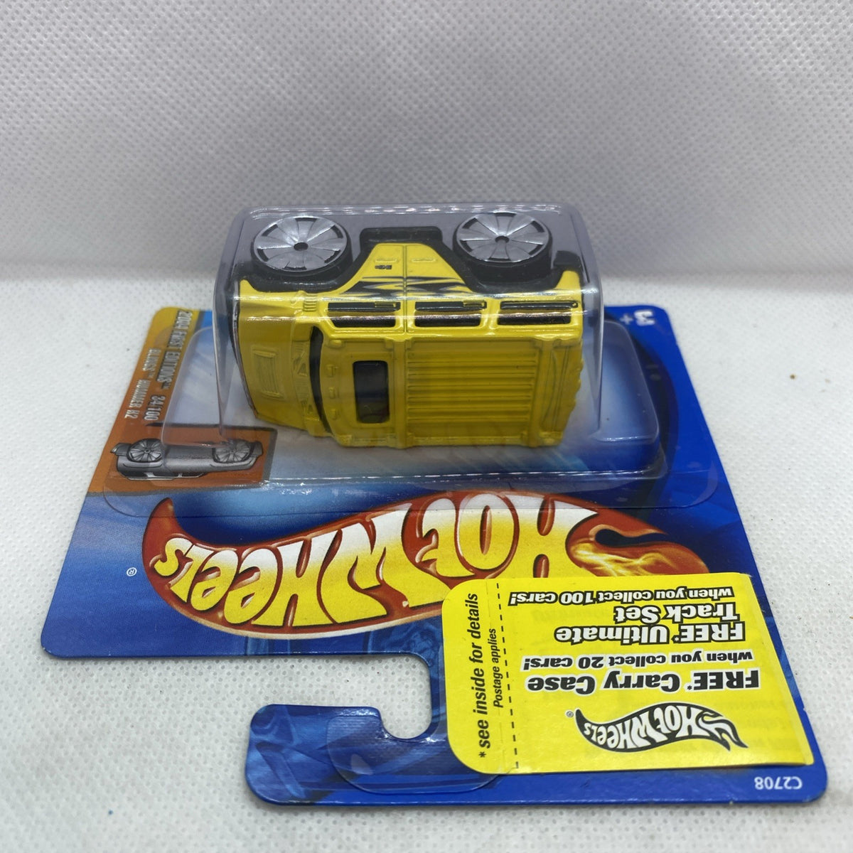 Hot Wheels yellow Hummer H2 2004 die-cast truck showing top and front wheels in blister