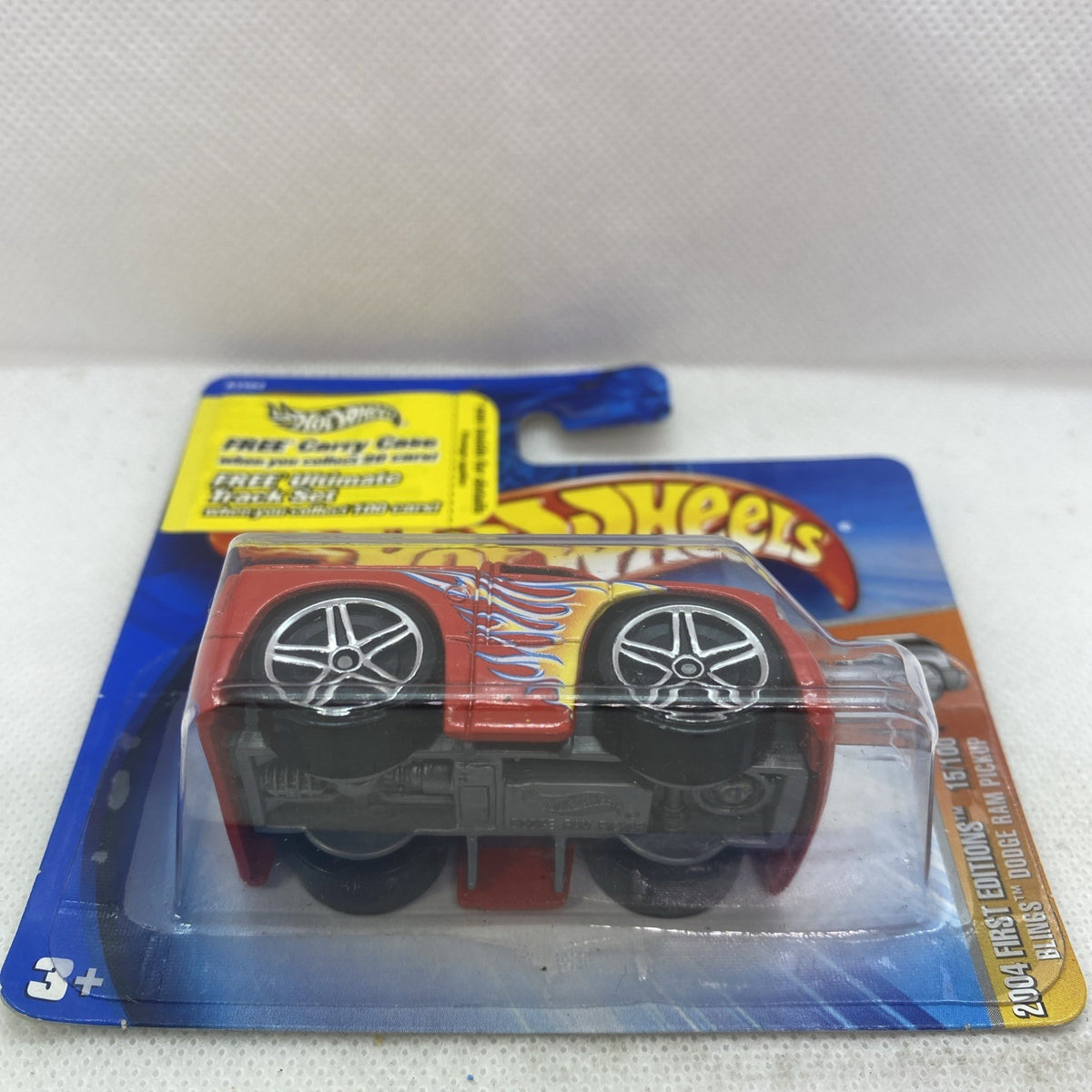 Hot Wheels Dodge Ram 2004 die-cast pickup in orange with flame decals, front side view