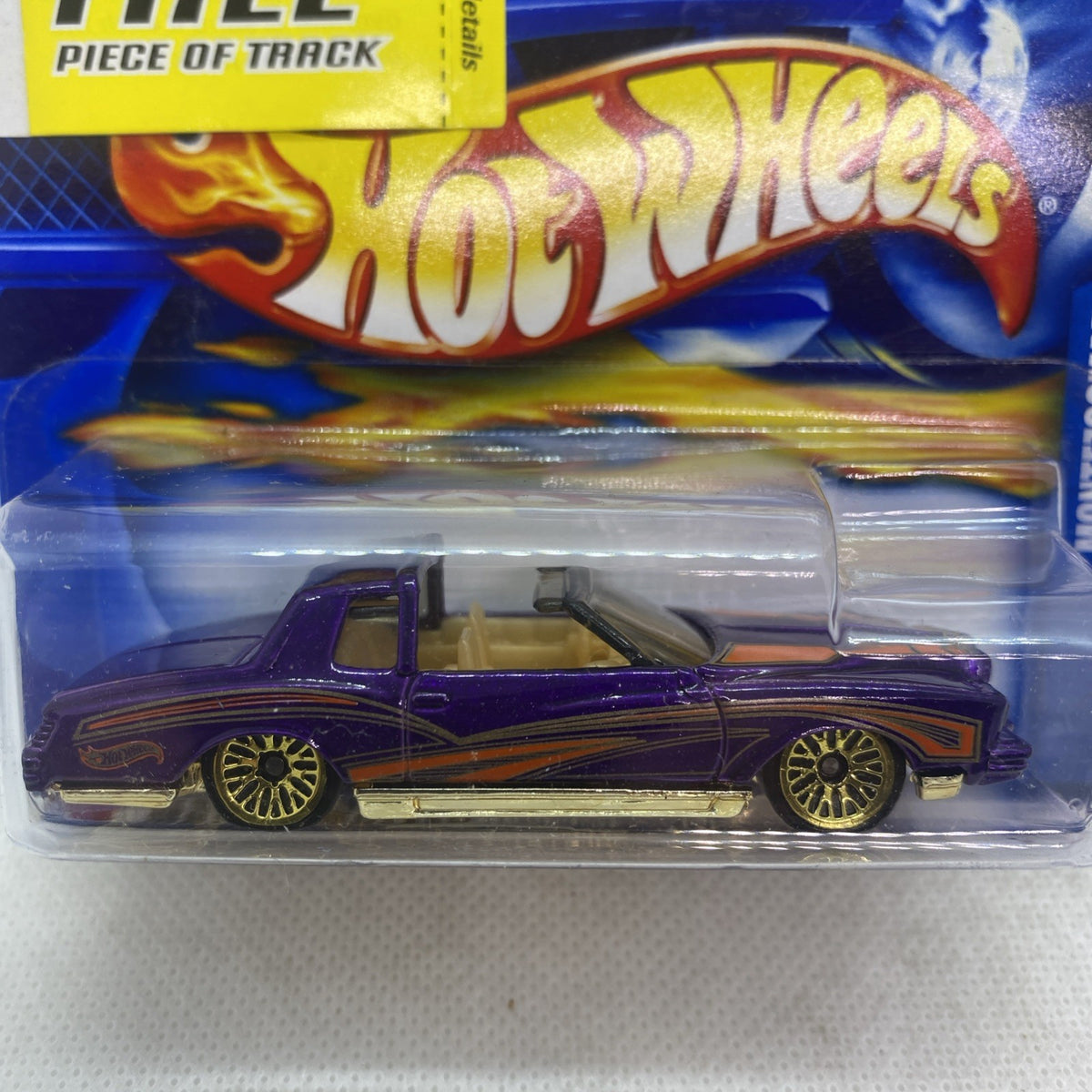 Hot Wheels metallic purple die-cast car in clear blister, close-up front