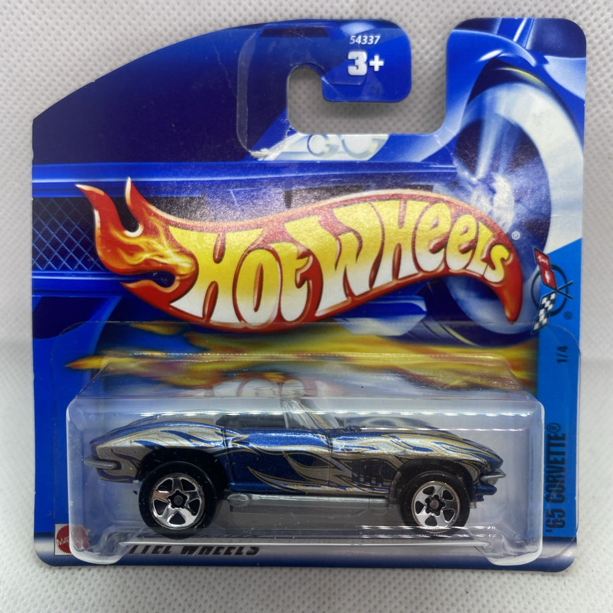 Hot Wheels die-cast Corvette on blue short card, clear blister and flame graphics