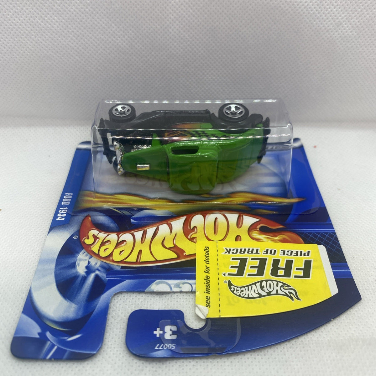 Hot Wheels green '34 Ford die-cast car in blister packaging, side view