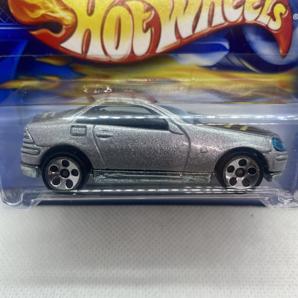 Hot Wheels Mercedes-Benz SLK 2001 silver toy car close-up, side profile