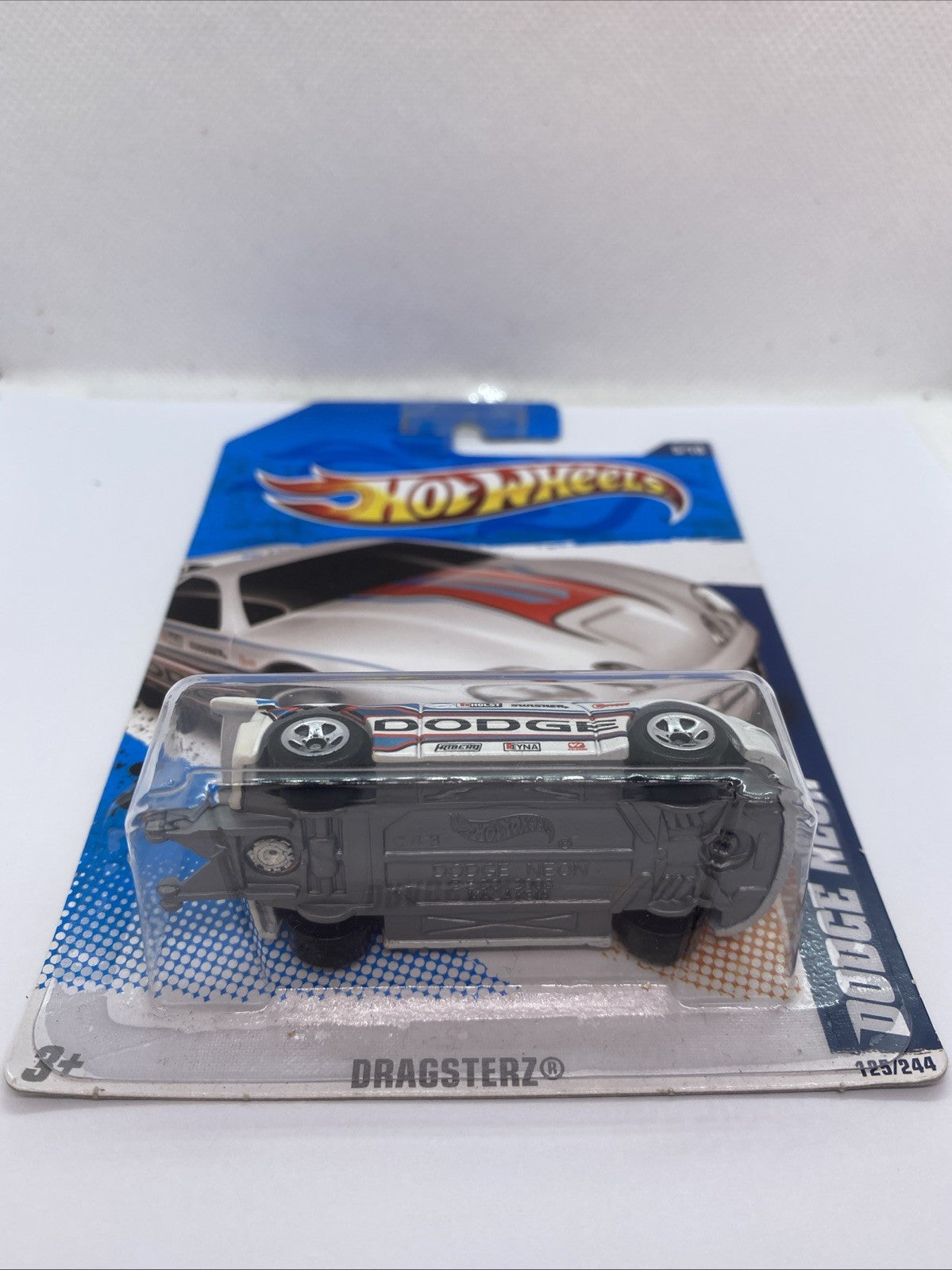 Diecast dragster in blister, view of underside with wheels and chassis detail