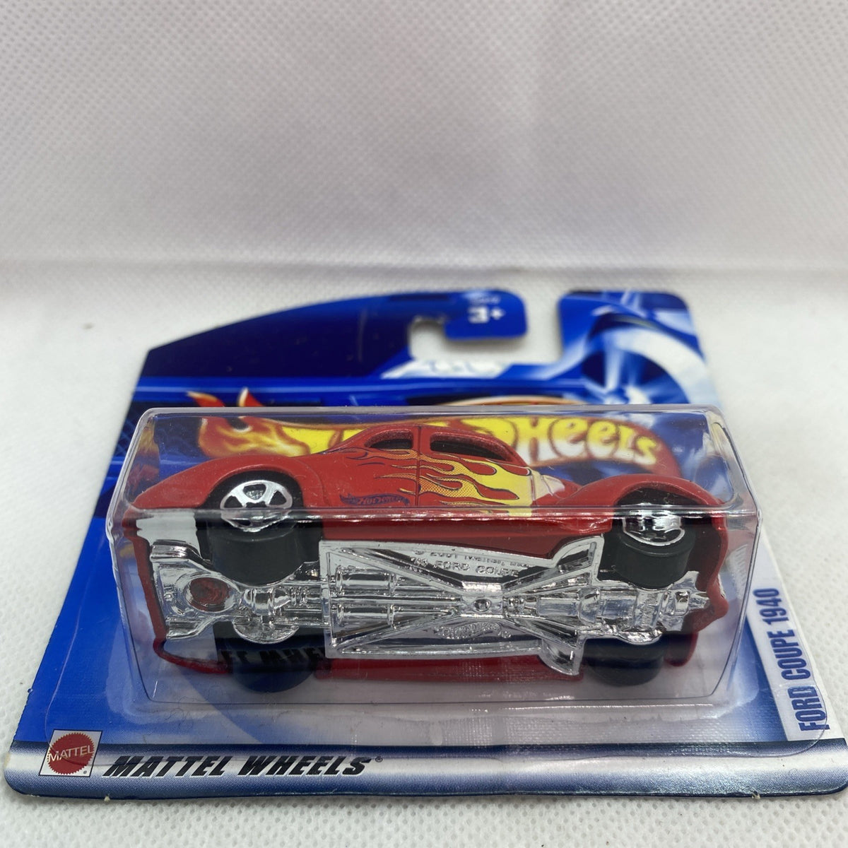 Hot Wheels red coupe toy with exposed chrome undercarriage, blister on card