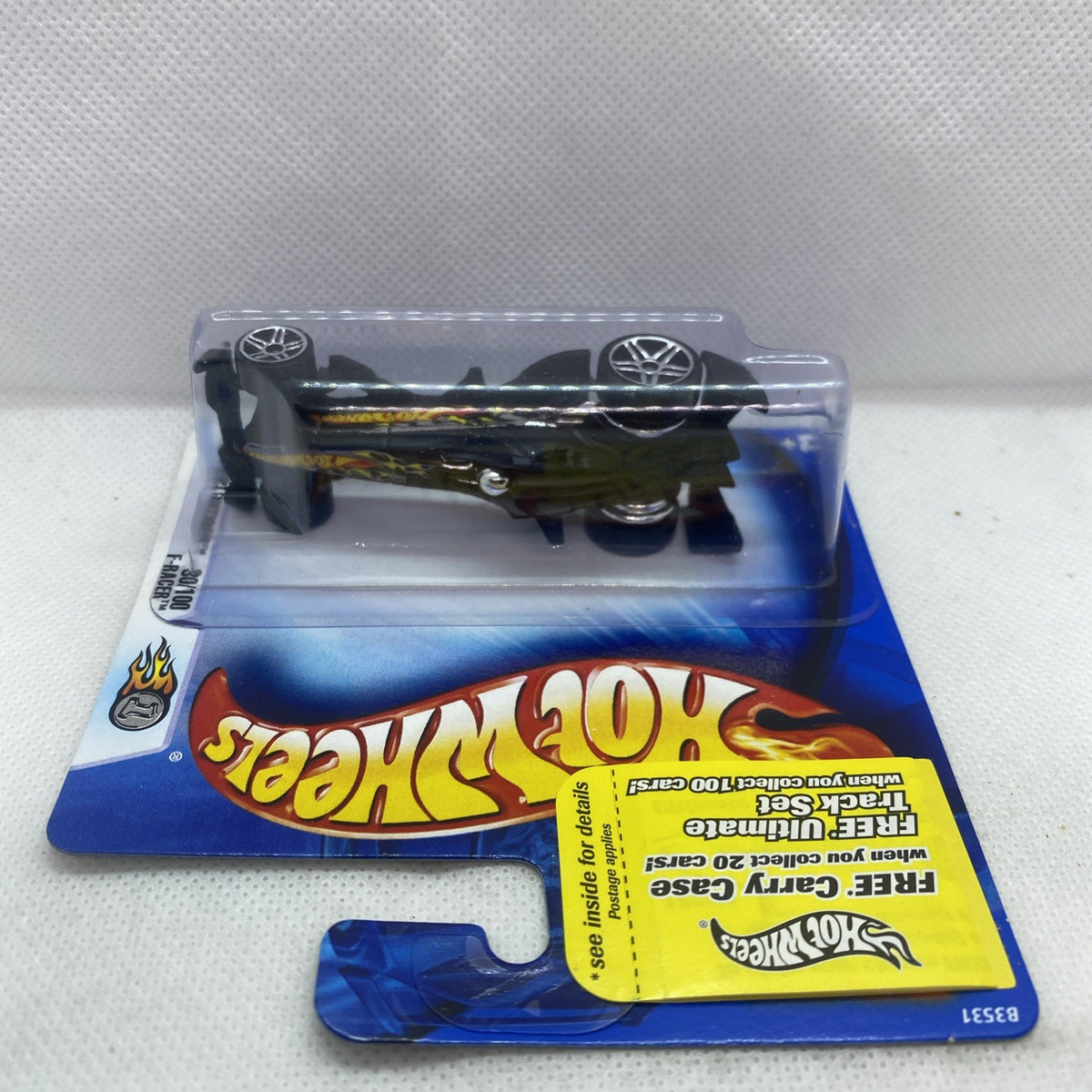 Hot Wheels F-Racer 2004 blister card with black car, top view through plastic
