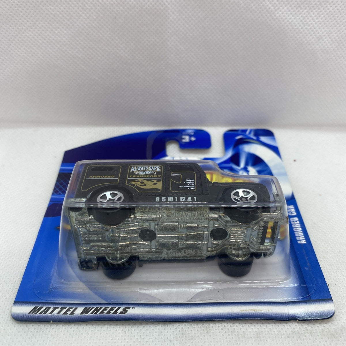 Hot Wheels armored car die-cast on card with underside details visible