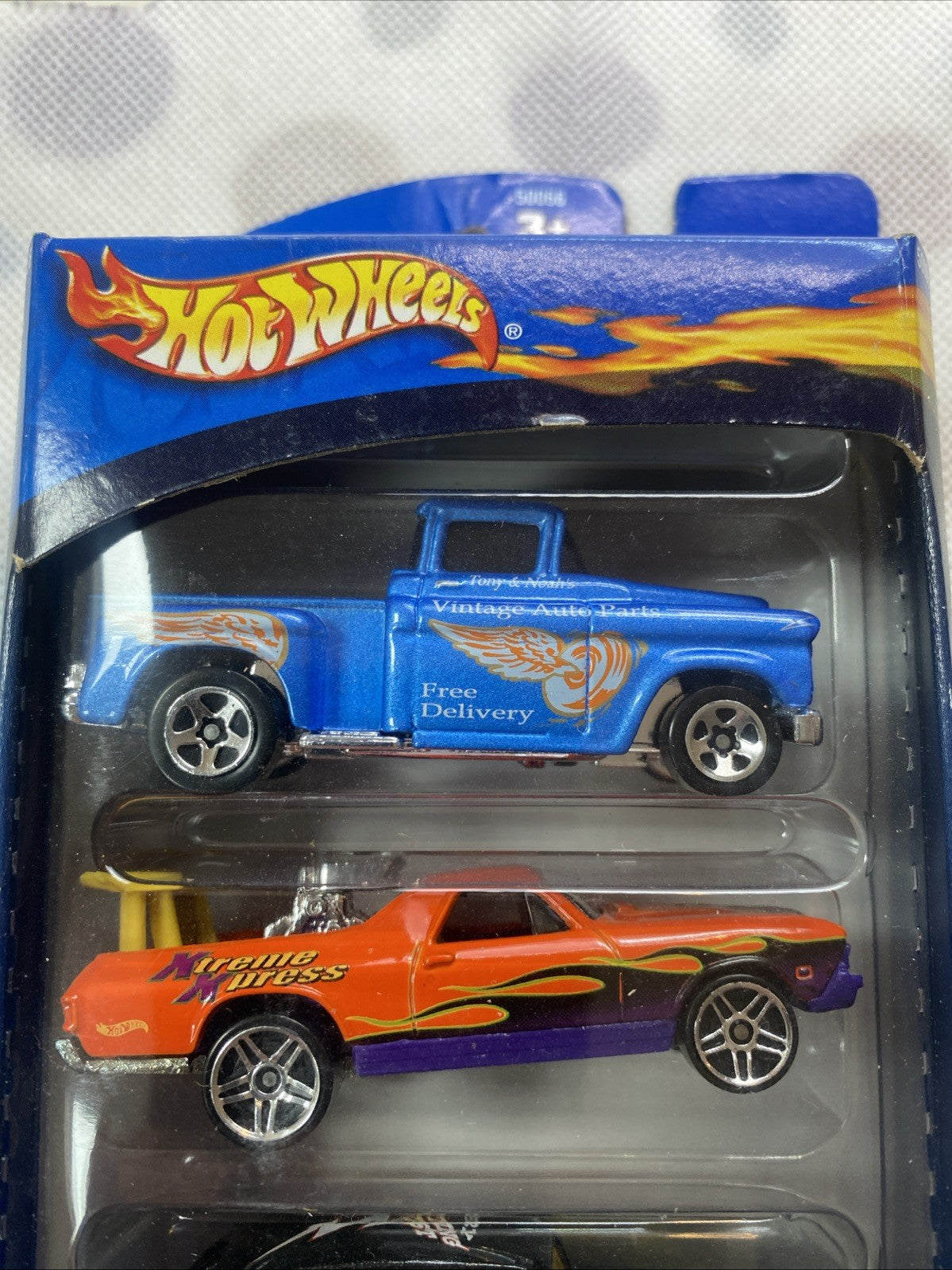 Hot Wheels Truck Stoppers 5-pack blister with blue pickup and orange race car